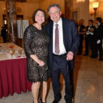 Couple posing in the ballroom at the June 2025 dinner