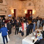 Guests mingling in the marble lobby at the June 2025 dinner