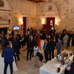 Guests at cocktail tables in the grand hall